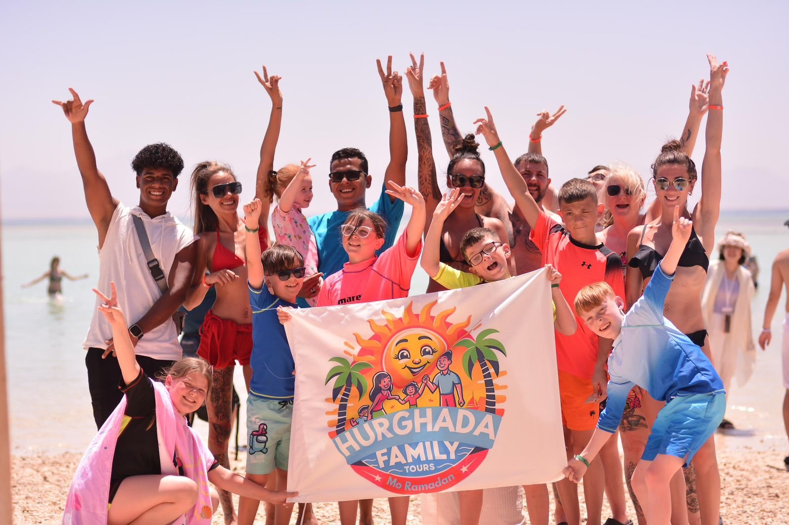 Happy families celebrating on the beach with Hurghada Family Tours